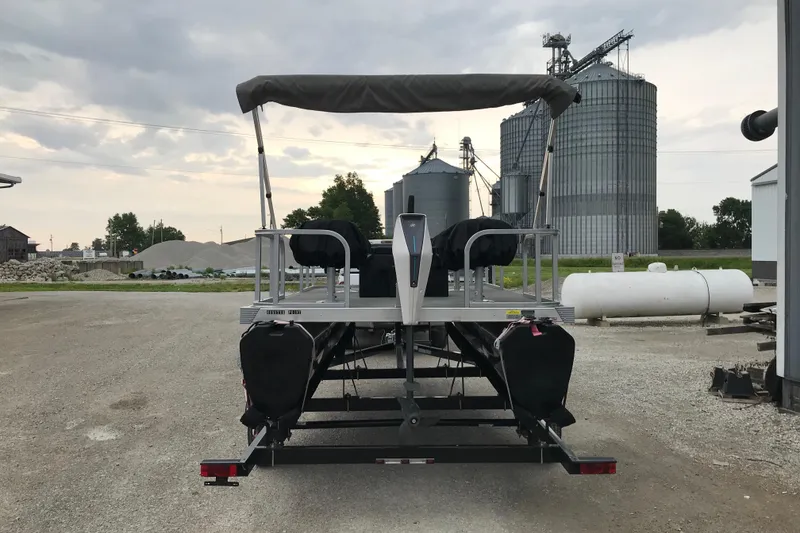 Slide: The Image of 2024 Tigershark 700 12' Mini Pontoon on trailer, industrial background. - 17