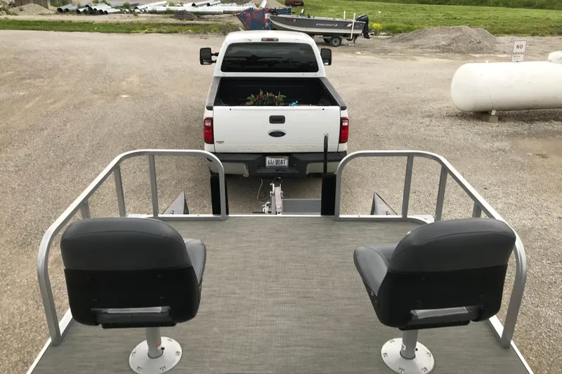 Slide: The Image of 2024 Tigershark 700 12' Mini Pontoon hitched to a white pickup truck. - 7