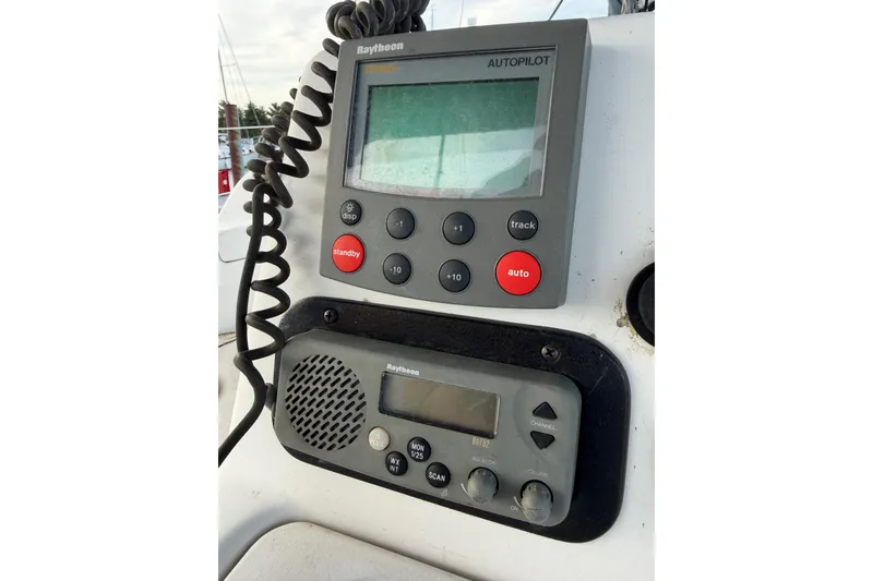Slide: The Image of Autopilot and radio controls on a 2000 Hunter 310 sailboat dashboard. - 11