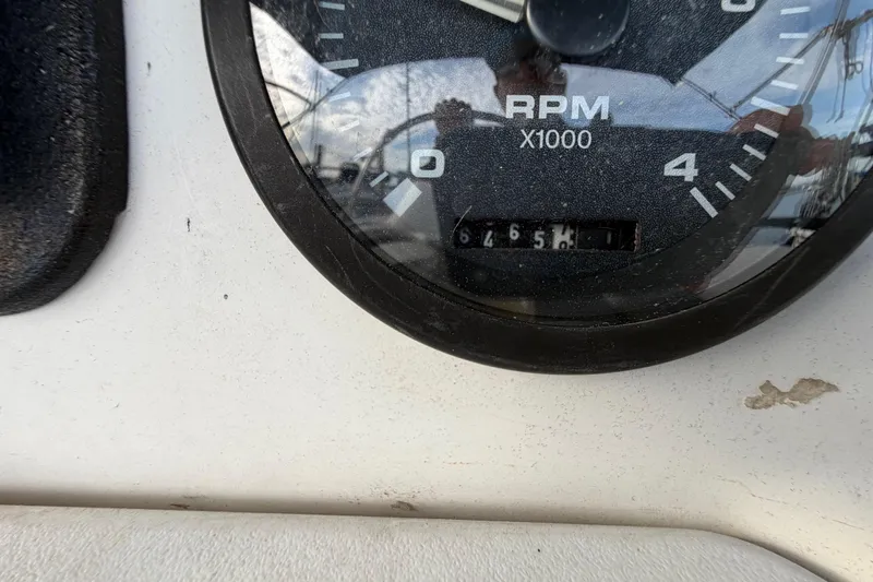 Slide: The Image of Close-up of a 2000 Hunter 310 RPM gauge displaying 6456 hours. - 12