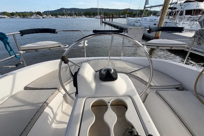 Slide: The Image of Cockpit view of a 2000 Hunter 310 sailboat at a marina. - 16