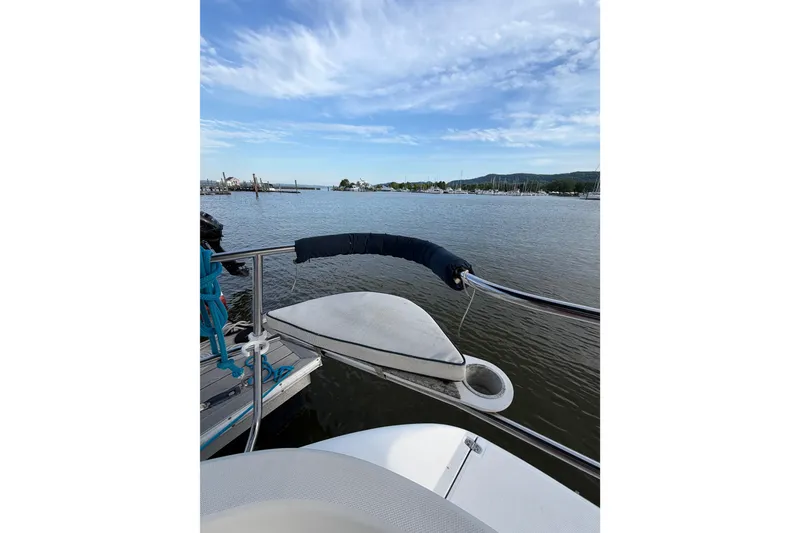 Slide: The Image of Sailboat deck view on water, Hunter 310, 2000 model, with scenic marina backdrop. - 17