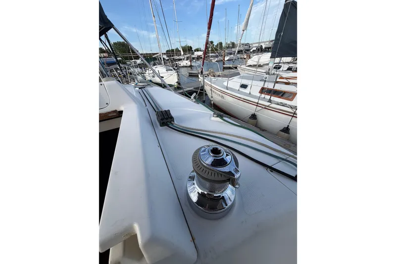 Slide: The Image of Hunter 310 sailboat deck view, 2000 model, docked in a marina with other boats. - 18