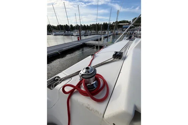 Slide: The Image of Sailboat deck with red rope and winch, docked at marina. Hunter 310, 2000 model. - 19