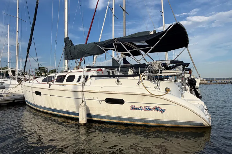 Slide: The Image of Sailboat Hunter 310, year 2000, docked at marina under clear blue sky. - 2