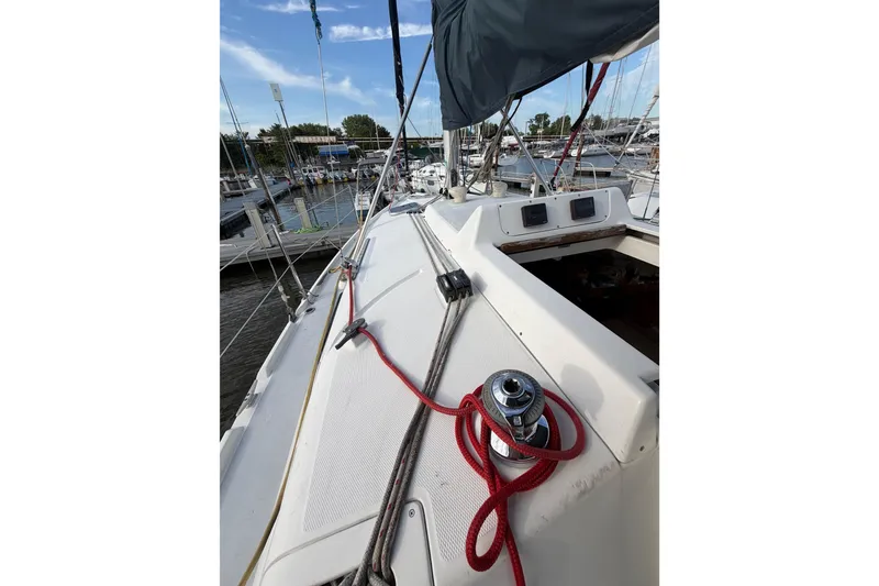 Slide: The Image of Sailboat deck view of a 2000 Hunter 310, docked at a marina. - 20