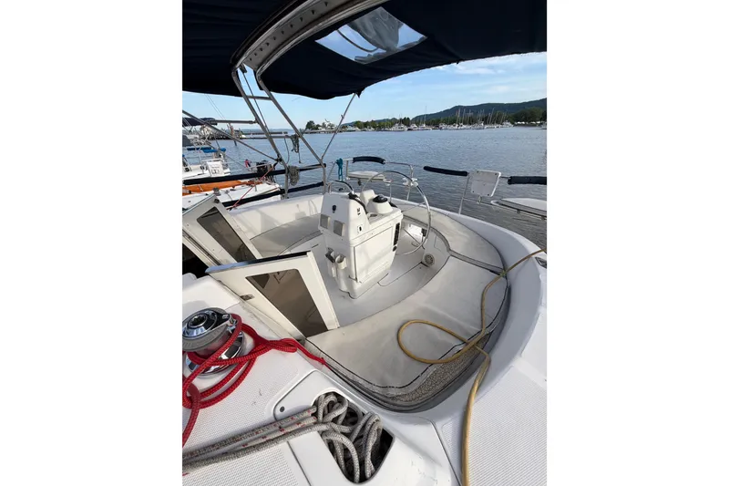 Slide: The Image of Cockpit of a 2000 Hunter 310 sailboat docked at a marina. - 21