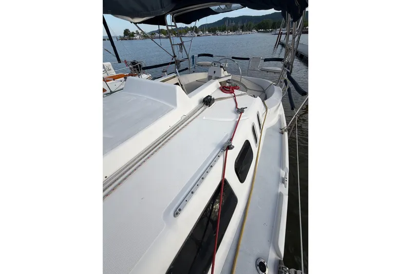 Slide: The Image of 2000 Hunter 310 sailboat docked, showcasing deck and cockpit area. - 23