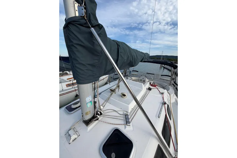 Slide: The Image of Sailboat deck view of 2000 Hunter 310 with covered mast and rigging. - 24