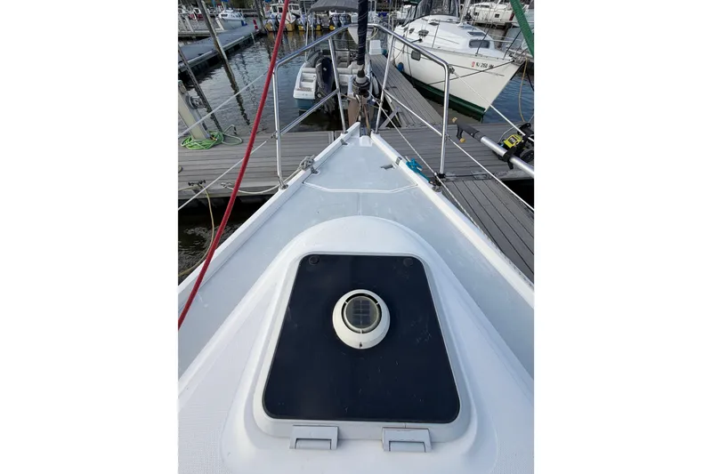 Slide: The Image of Bow view of a 2000 Hunter 310 sailboat docked at a marina. - 25