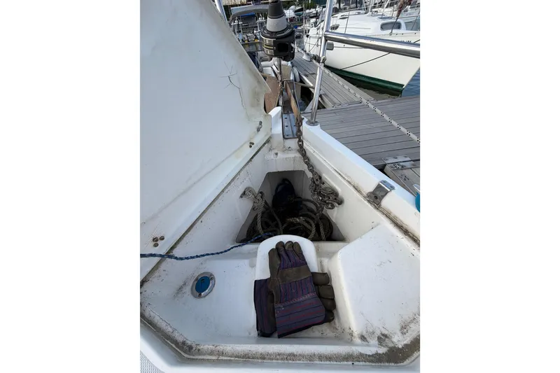 Slide: The Image of Anchor locker of a 2000 Hunter 310 sailboat with gloves and ropes. - 26
