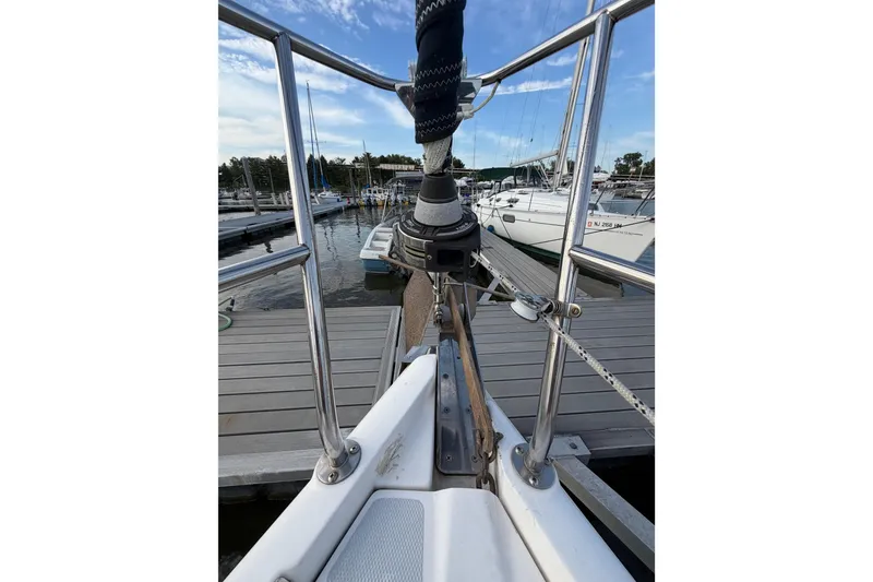 Slide: The Image of Bow view of a 2000 Hunter 310 sailboat docked at a marina. - 28