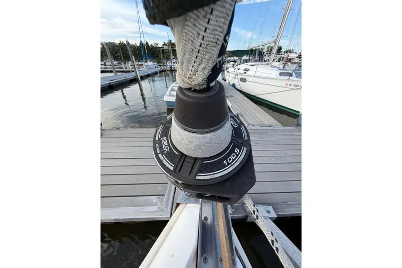 Slide: The Image of Furlex 100S roller furling system on a 2000 Hunter 310 sailboat at a marina. - 29