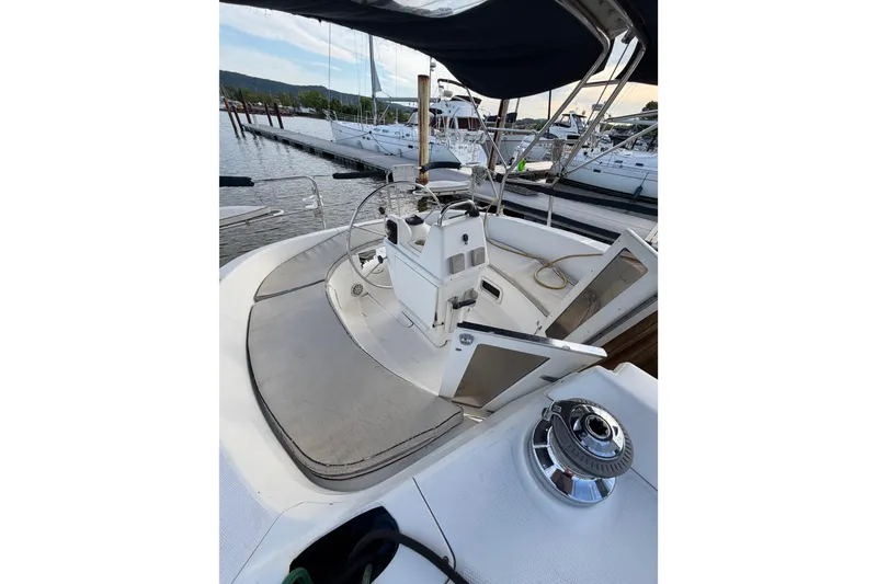 Slide: The Image of 2000 Hunter 310 sailboat cockpit with steering wheel, docked at marina. - 34