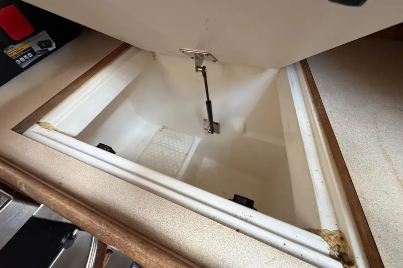 Slide: The Image of Open storage compartment in a 2000 Hunter 310 boat interior. - 41