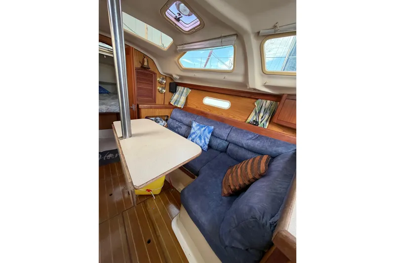 Slide: The Image of Interior of 2000 Hunter 310 sailboat with cozy seating and table. - 43