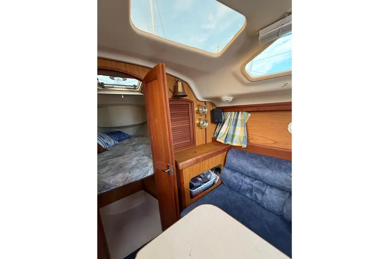 Slide: The Image of Interior of a 2000 Hunter 310 sailboat with cozy cabin and wooden furnishings. - 47