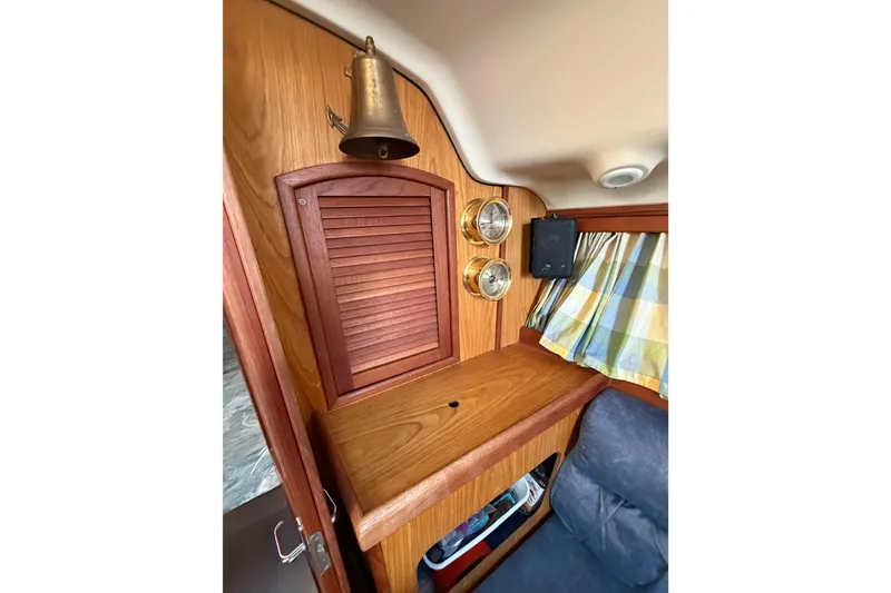 Slide: The Image of Interior of 2000 Hunter 310 sailboat with wooden cabinetry and nautical decor. - 48