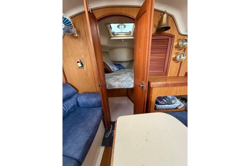 Slide: The Image of Interior of a 2000 Hunter 310 sailboat with cozy cabin and wooden accents. - 50
