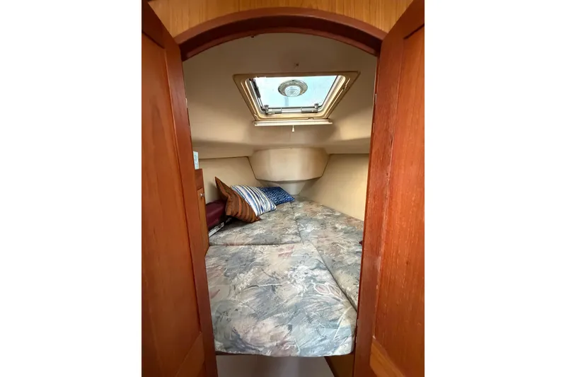 Slide: The Image of Cozy cabin interior of 2000 Hunter 310 sailboat with skylight and patterned bedding. - 51