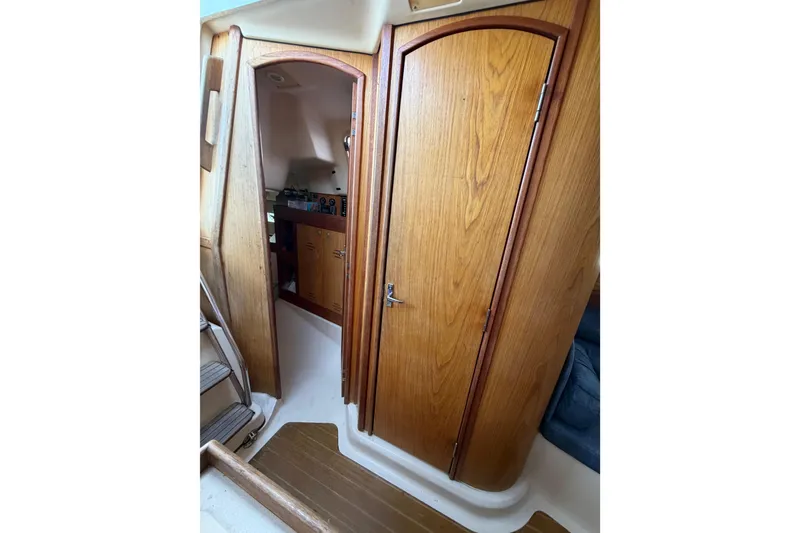 Slide: The Image of Interior of a 2000 Hunter 310 sailboat with wooden cabinetry and compact design. - 56