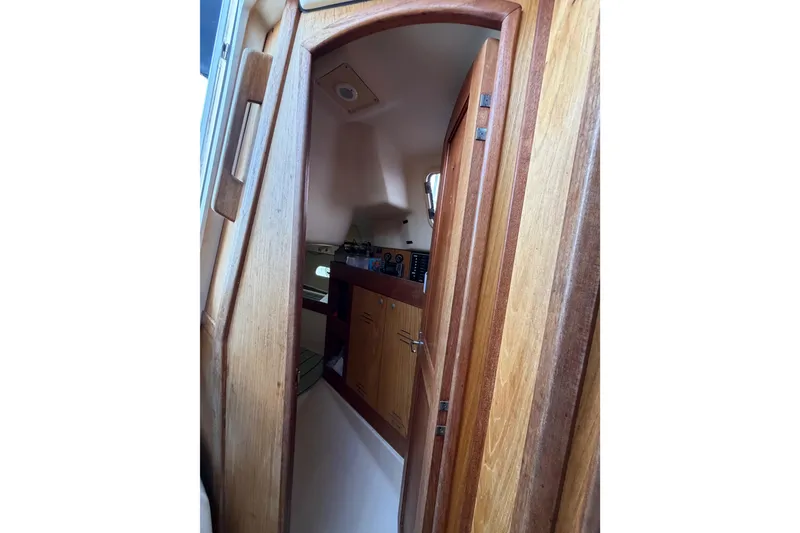 Slide: The Image of Interior view of a 2000 Hunter 310 sailboat with wooden cabinetry. - 57