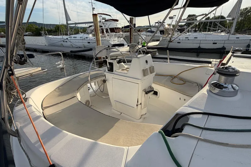 Slide: The Image of Cockpit of a 2000 Hunter 310 sailboat docked at a marina. - 6