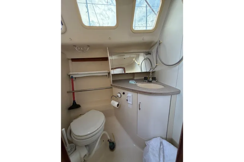 Slide: The Image of Compact bathroom in a 2000 Hunter 310 sailboat with skylight and modern amenities. - 64
