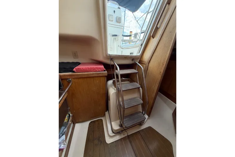 Slide: The Image of Interior of a 2000 Hunter 310 sailboat with wooden steps and cabinetry. - 65