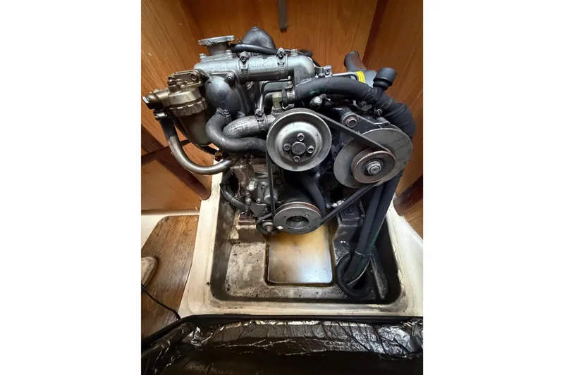 Slide: The Image of Engine of a 2000 Hunter 310 sailboat, showcasing belts and components. - 67