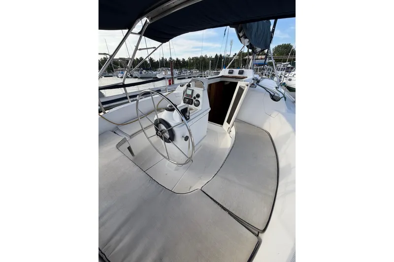 Slide: The Image of Cockpit of a 2000 Hunter 310 sailboat with steering wheel and navigation instruments. - 7