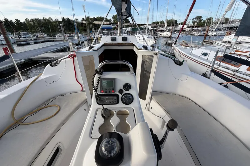 Slide: The Image of Cockpit view of a 2000 Hunter 310 sailboat docked at a marina. - 9