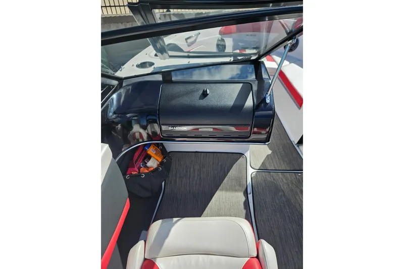 Slide: The Image of Interior of a 2021 Glastron GTS 205 boat, featuring sleek dashboard and seating. - 10