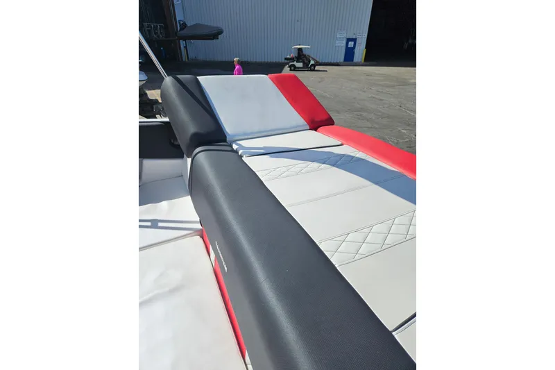 Slide: The Image of 2021 Glastron GTS 205 boat interior with red, black, and white seating. - 13