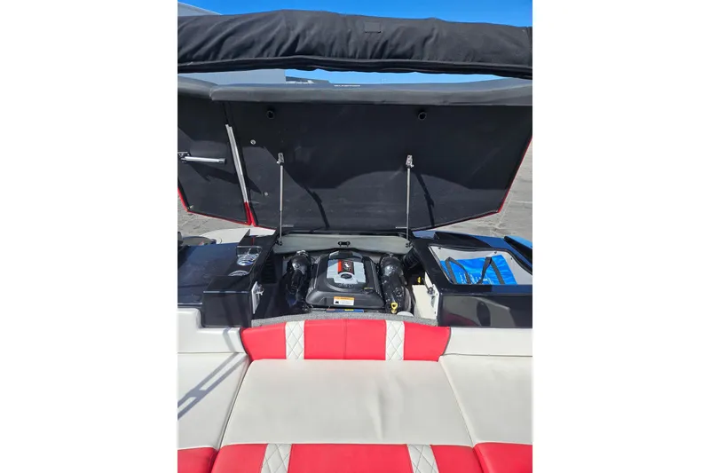 Slide: The Image of 2021 Glastron GTS 205 boat engine compartment with red and white seating. - 15