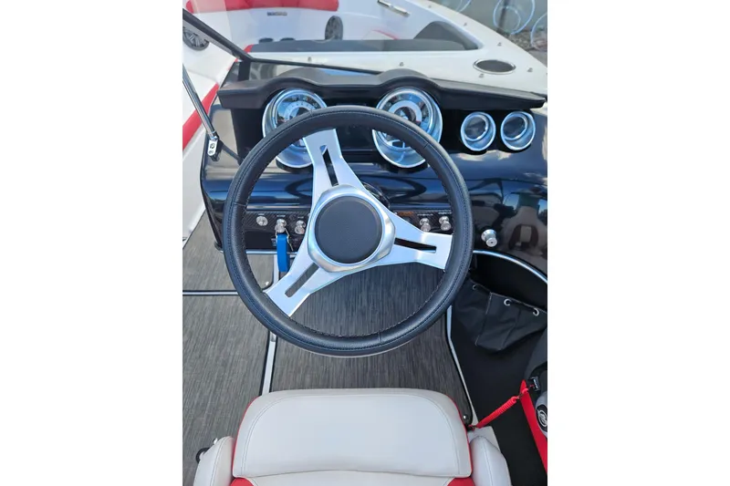 Slide: The Image of 2021 Glastron GTS 205 boat dashboard with steering wheel and gauges. - 8