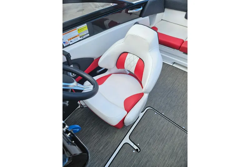 Slide: The Image of 2021 Glastron GTS 205 boat interior with red and white captain's seat. - 9