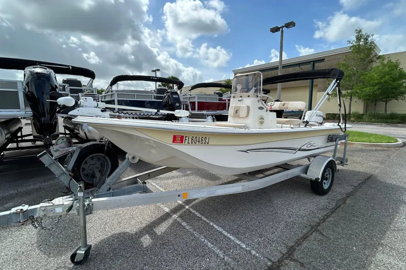 The Image of 2015 Carolina Skiff JVX18CC boat on trailer, parked outdoors under cloudy sky. - 0
