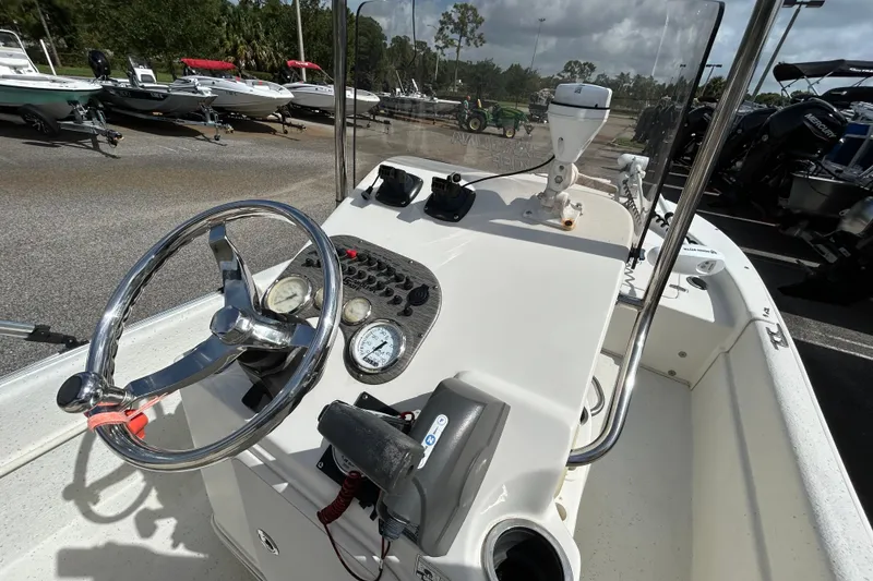 Slide: The Image of 2015 Carolina Skiff JVX18CC boat console with steering wheel and gauges. - 11