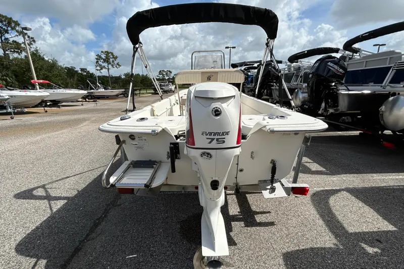 Slide: The Image of 2015 Carolina Skiff JVX18CC boat with Evinrude 75 engine, parked outdoors. - 3