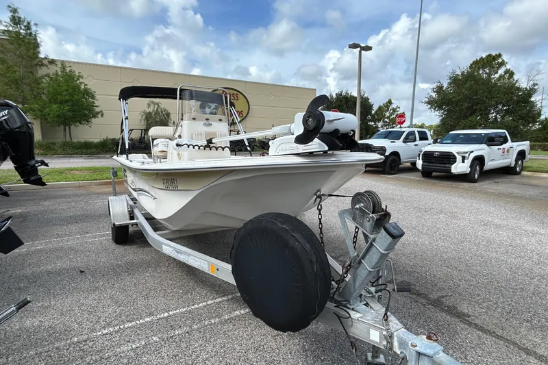 Slide: The Image of 2015 Carolina Skiff JVX18CC boat on trailer in parking lot, cloudy sky background. - 5
