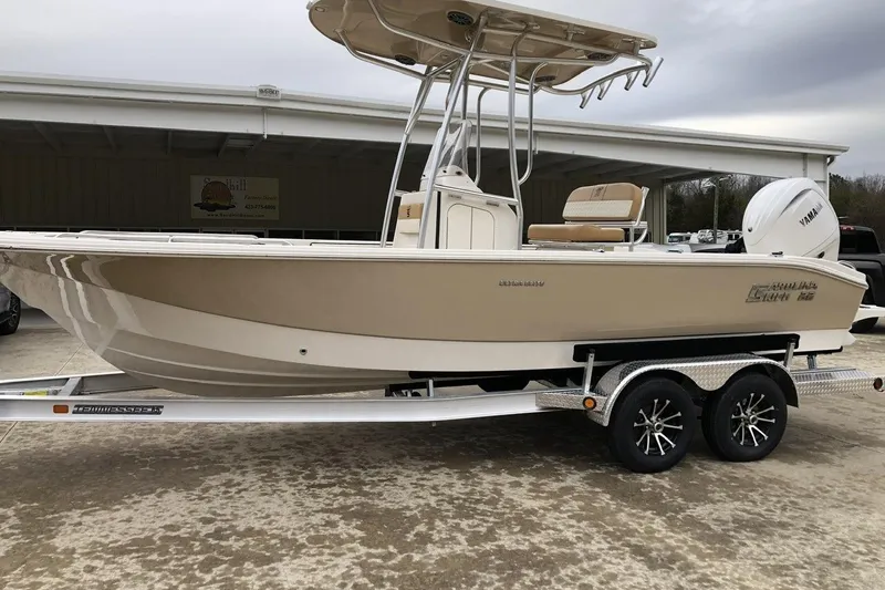 The Image of 2025 Carolina Skiff 22 Ultra Elite boat on trailer, beige and white design. - 1