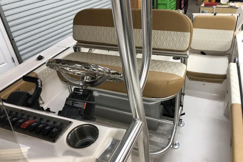 Slide: The Image of Interior of 2025 Carolina Skiff 22 Ultra Elite boat with beige and white seating. - 11