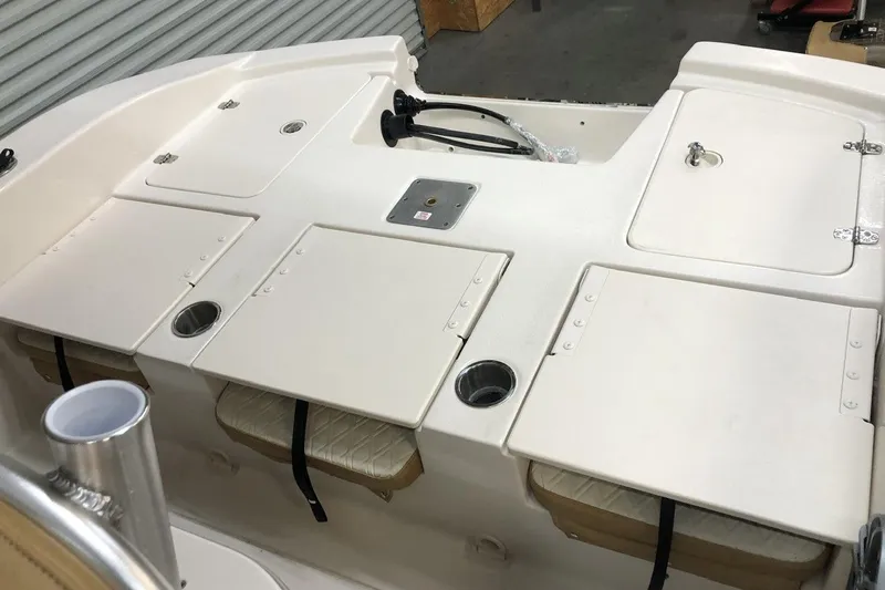 Slide: The Image of 2025 Carolina Skiff 22 Ultra Elite boat interior with storage compartments and cup holders. - 13