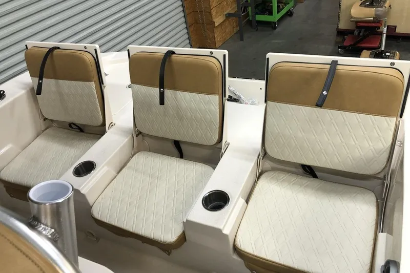 Slide: The Image of 2025 Carolina Skiff 22 Ultra Elite boat seats with beige and white upholstery. - 14