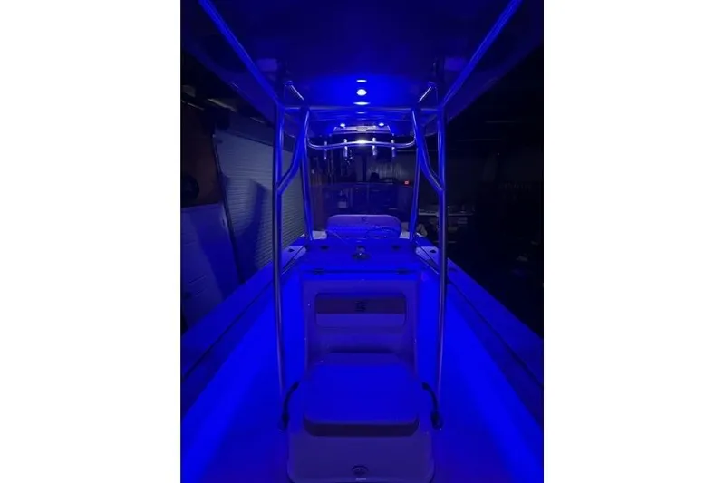 Slide: The Image of 2025 Carolina Skiff 22 Ultra Elite boat interior with blue LED lighting. - 4