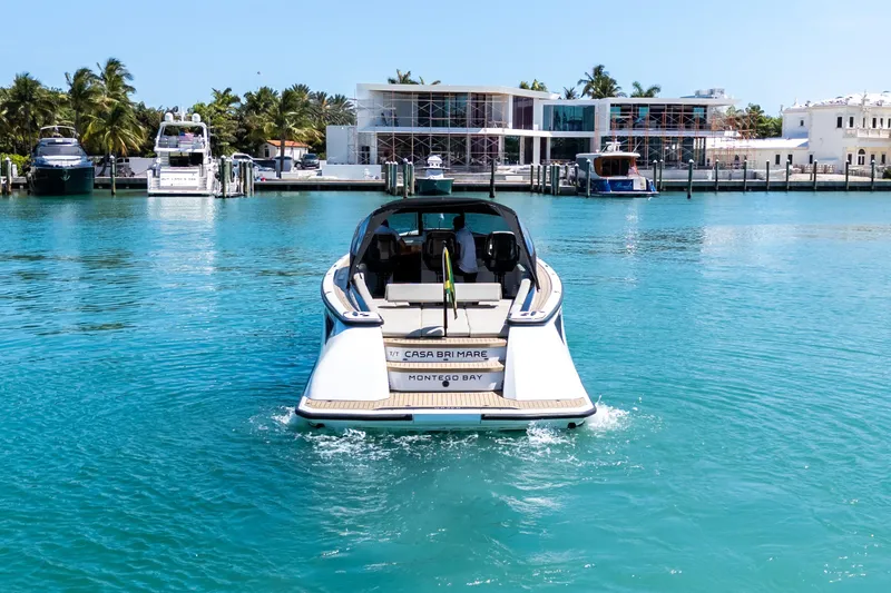 Slide: The Image of 2022 Wajer 38 yacht cruising in turquoise waters near luxury waterfront homes. - 16