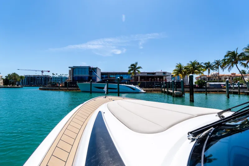 Slide: The Image of Wajer 38 yacht cruising in sunny marina, palm trees and buildings in background, 2022 model. - 3