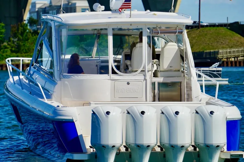 Slide: The Image of 2017 Intrepid 475 Sport Yacht with multiple outboard engines on the water. - 10