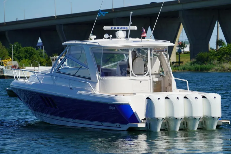 Slide: The Image of 2017 Intrepid 475 Sport Yacht with quad engines cruising near a bridge. - 11
